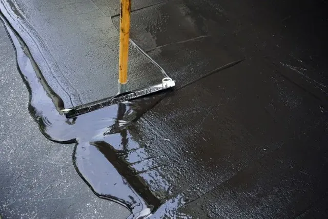 Asphalt sealcoating (seal coat) in St. George for cured driveways and parking lots — crack fill and patches first, then protection from UV, oxidation, and water.